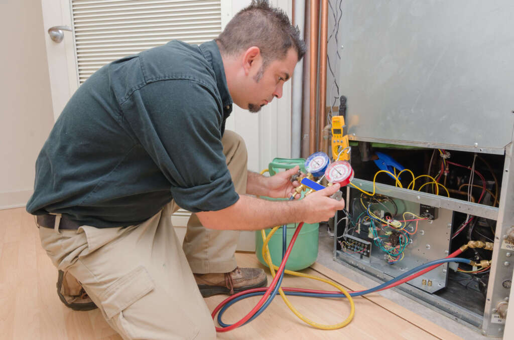 Air conditioner technician pressur testing an AC unit.